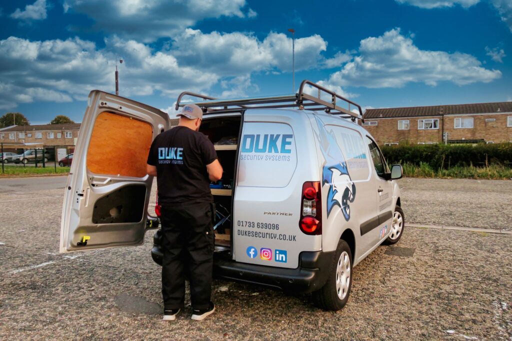 CCTV engineer working in the back of a duke security systems van