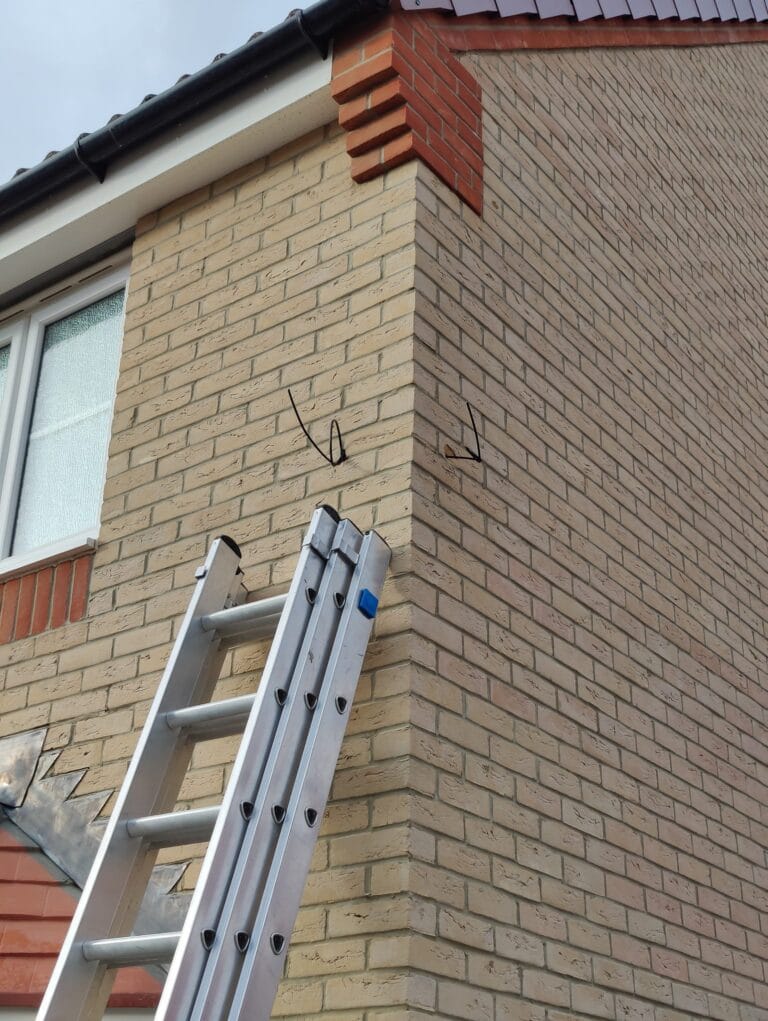 External grade CAT6 cable concealed in wall cavity during professional CCTV installation by Duke Security Systems Peterborough